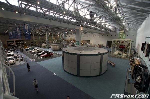 Giant warehouse of Toyota cars, engines, and car building machines.